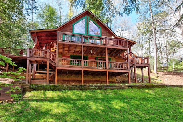 rear view of property with a wooden deck, a yard, and stairs