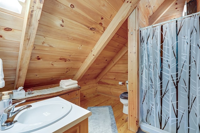 full bathroom featuring wood finished floors, wood ceiling, wood walls, toilet, and vanity
