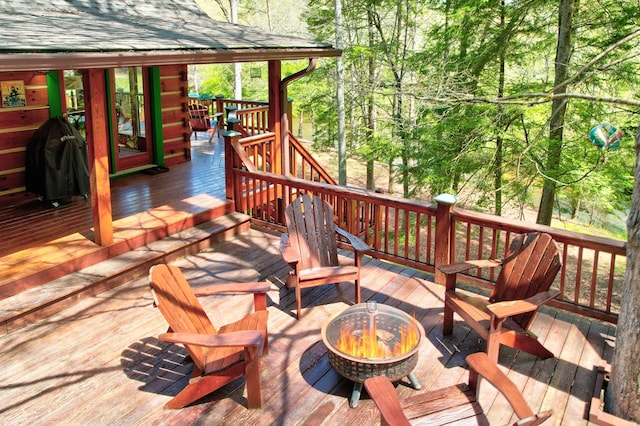 wooden deck with a fire pit
