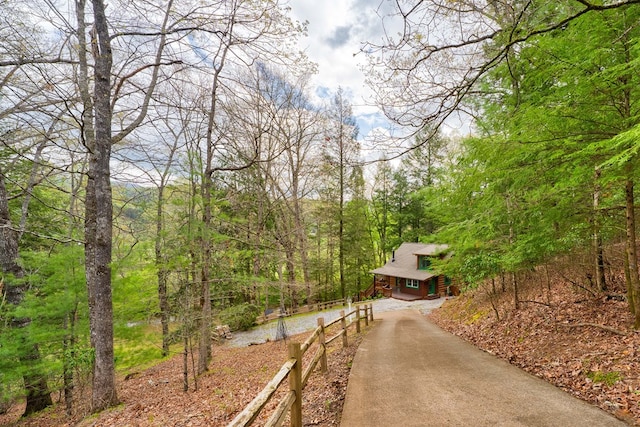 exterior space with driveway and a forest view