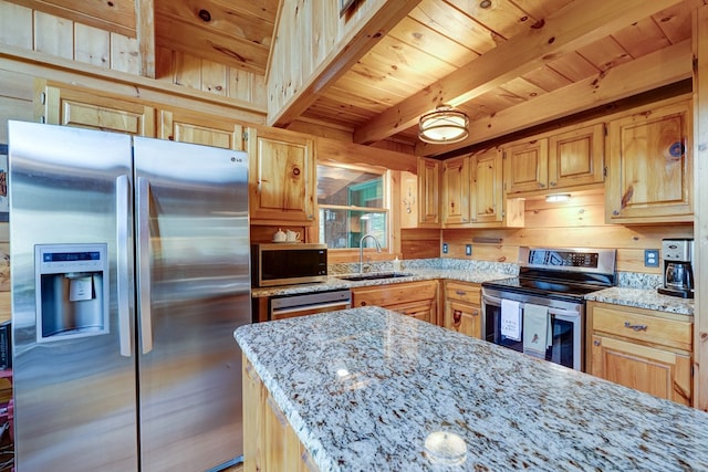 kitchen with light stone counters, beamed ceiling, a sink, appliances with stainless steel finishes, and wooden ceiling