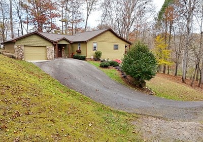 ranch-style home with a front lawn and a garage