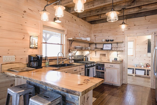 150 Laurel Trce, Blue Ridge, GA 30513 - kitchen with stainless steel gas stove, a sink, wood counters, wood walls, and beamed ceiling