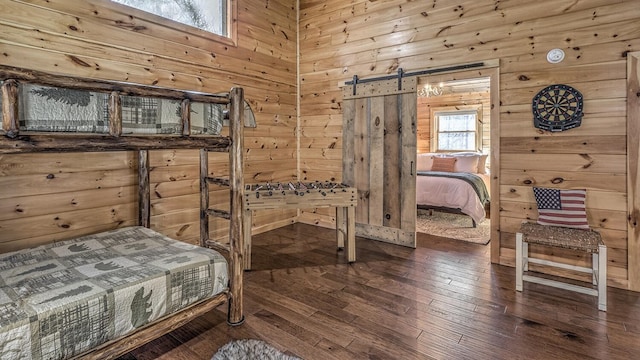 150 Laurel Trce, Blue Ridge, GA 30513 - bedroom featuring wooden walls, wood-type flooring, and a barn door