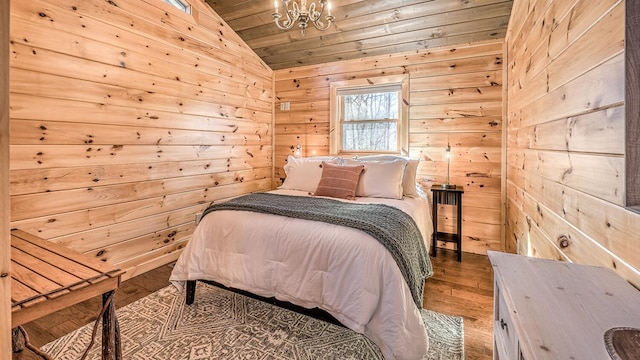 150 Laurel Trce, Blue Ridge, GA 30513 - bedroom featuring lofted ceiling, wood finished floors, wood ceiling, wooden walls, and a chandelier