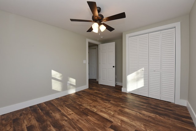 16 Sims Rd, Hiawassee, GA 30546 - unfurnished bedroom featuring ceiling fan, a closet, baseboards, and dark wood-style flooring