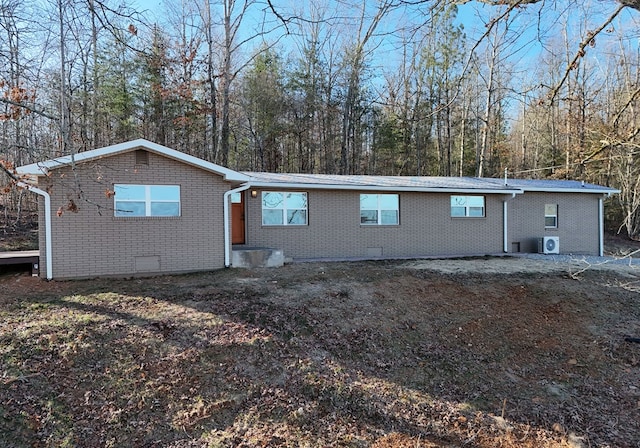 view of front of property with brick siding and crawl space