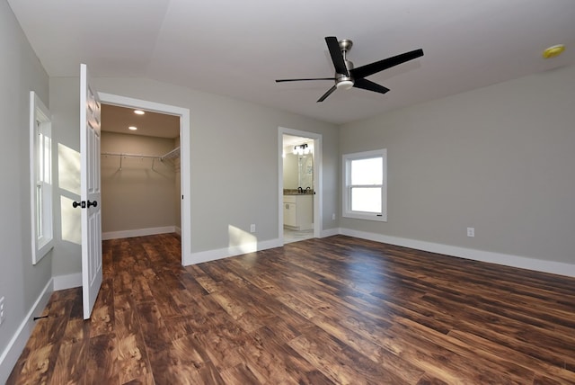 16 Sims Rd, Hiawassee, GA 30546 - unfurnished bedroom with dark wood-type flooring, a closet, a walk in closet, and baseboards