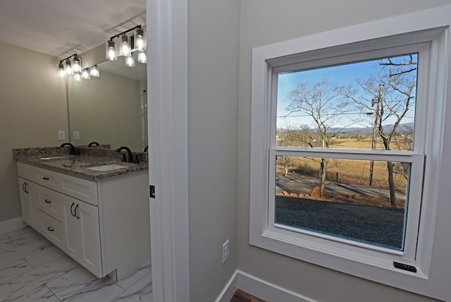 16 Sims Rd, Hiawassee, GA 30546 - bathroom featuring double vanity, marble finish floor, baseboards, and a sink