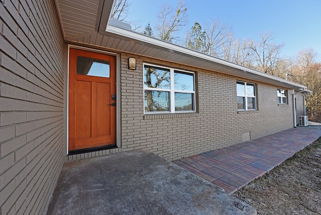16 Sims Rd, Hiawassee, GA 30546 - entrance to property with cooling unit, a patio area, brick siding, and crawl space