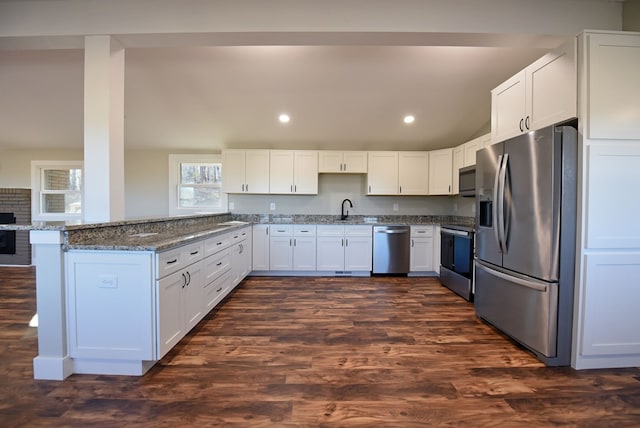 16 Sims Rd, Hiawassee, GA 30546 - kitchen featuring stainless steel appliances, a peninsula, a sink, white cabinets, and dark stone counters