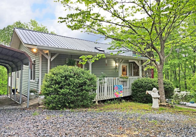 view of property exterior featuring a carport, a standing seam roof, and metal roof