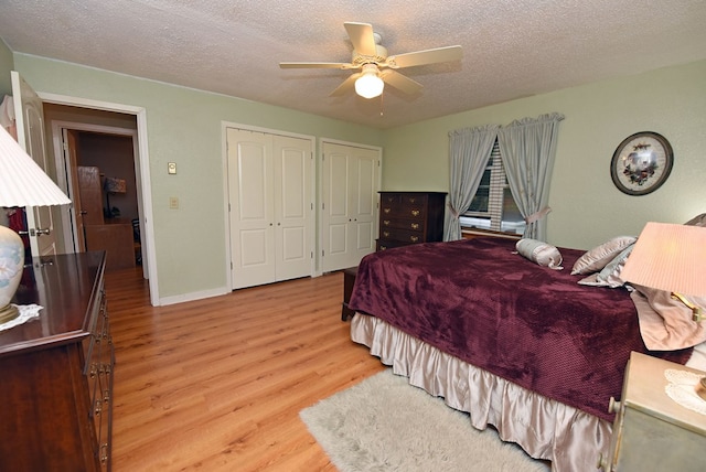 bedroom featuring ceiling fan, light wood finished floors, and a textured ceiling