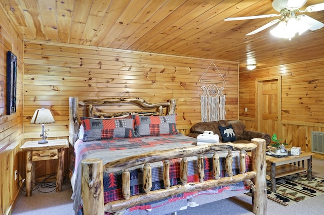 bedroom featuring ceiling fan, carpet floors, wooden walls, and wood ceiling