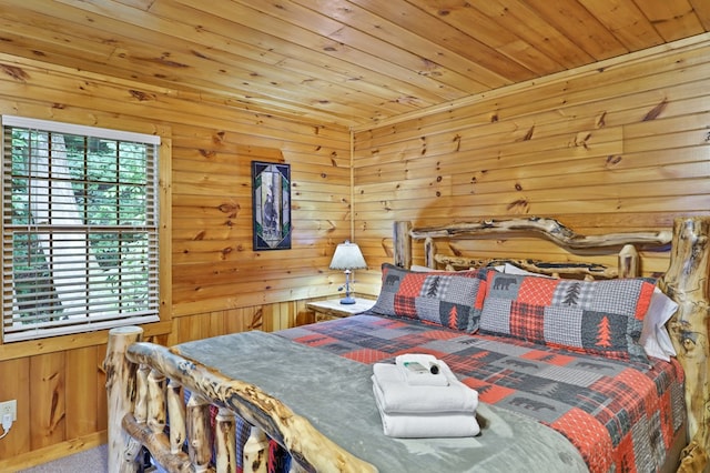 bedroom with wooden ceiling and wood walls