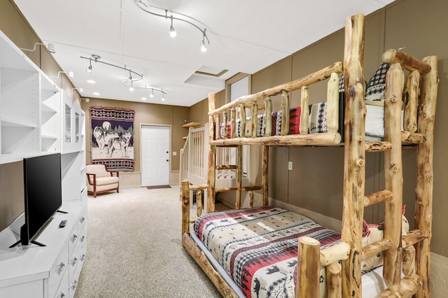 carpeted bedroom with track lighting