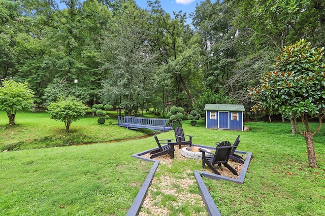 view of yard featuring a storage shed and a fire pit