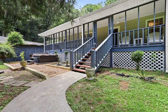 exterior space featuring a hot tub and ceiling fan