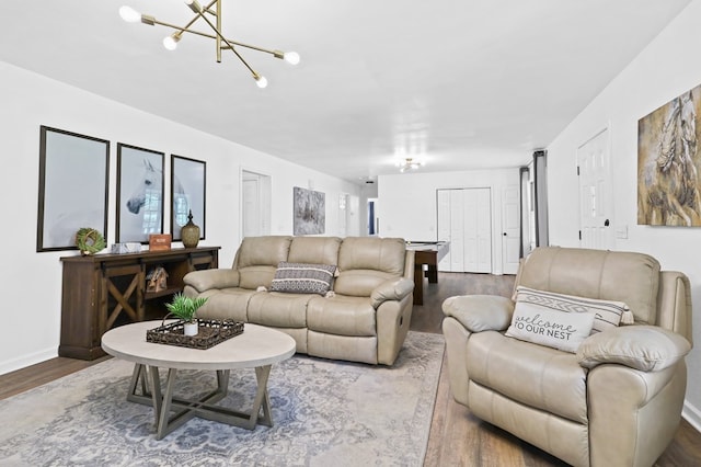 living room featuring hardwood / wood-style floors and a notable chandelier