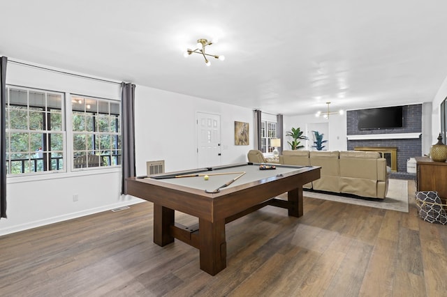 recreation room with pool table, plenty of natural light, and dark hardwood / wood-style floors