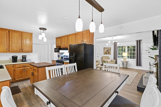 dining space with an inviting chandelier and dark wood-type flooring