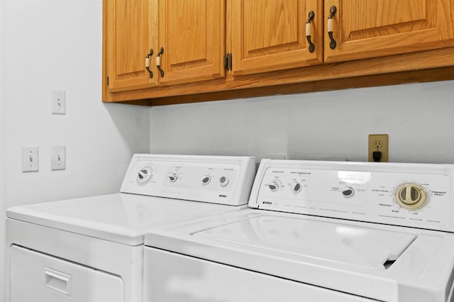 laundry area featuring cabinets and washing machine and clothes dryer