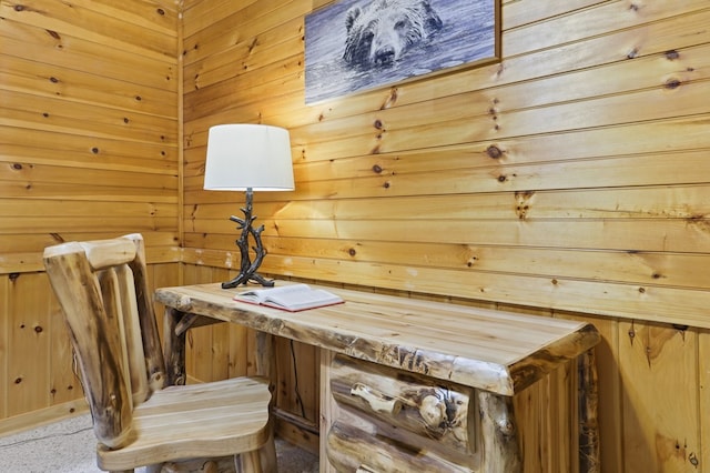 interior space featuring built in desk and wood walls