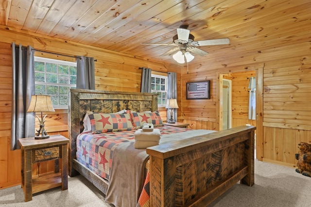 bedroom with light colored carpet, wooden ceiling, multiple windows, and wood walls