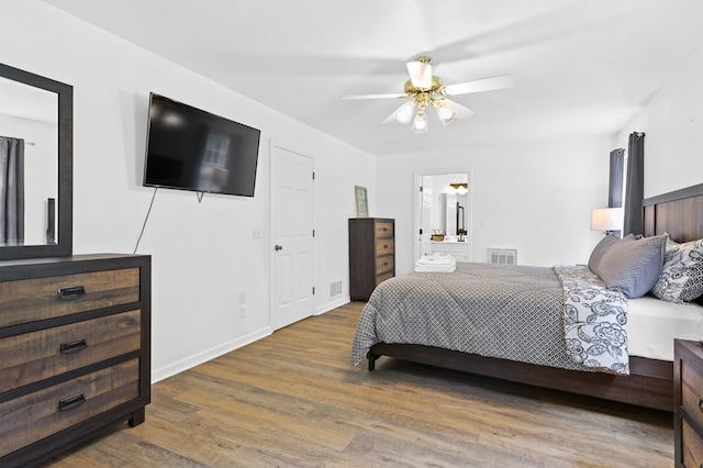 bedroom with hardwood / wood-style flooring, ceiling fan, and ensuite bathroom