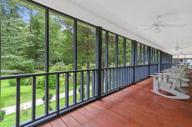 unfurnished sunroom with ceiling fan