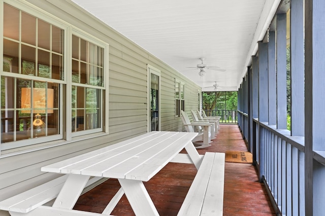 deck with covered porch and ceiling fan