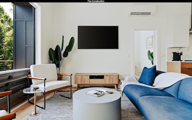 living room featuring a wall unit AC and light hardwood / wood-style flooring