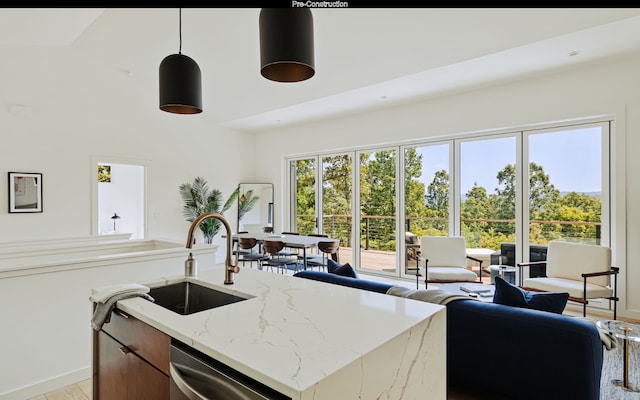 kitchen with decorative light fixtures, light stone counters, stainless steel dishwasher, high vaulted ceiling, and sink