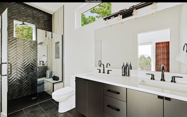 bathroom featuring tile flooring, dual vanity, and a wealth of natural light