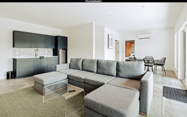 living room featuring sink and a wall mounted air conditioner