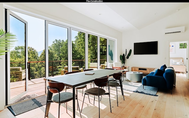 sunroom / solarium featuring vaulted ceiling and a wall mounted AC