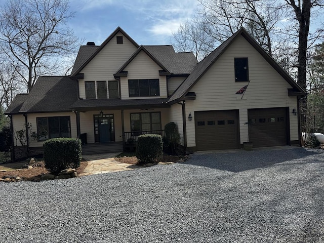 view of front facade featuring a porch, an attached garage, a shingled roof, driveway, and a chimney