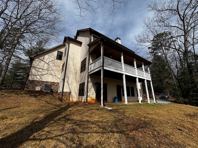 back of house with a chimney