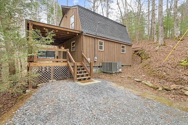 back of house with a wooden deck and central AC