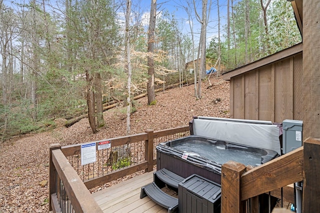wooden terrace featuring a hot tub