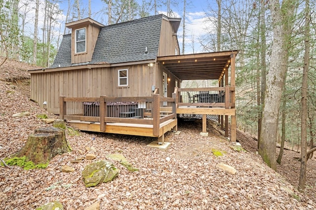 back of house featuring a wooden deck