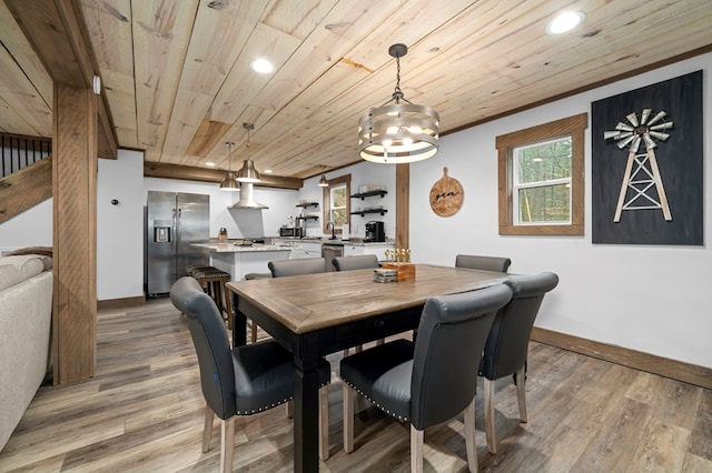 dining room featuring sink, wooden ceiling, and light hardwood / wood-style floors