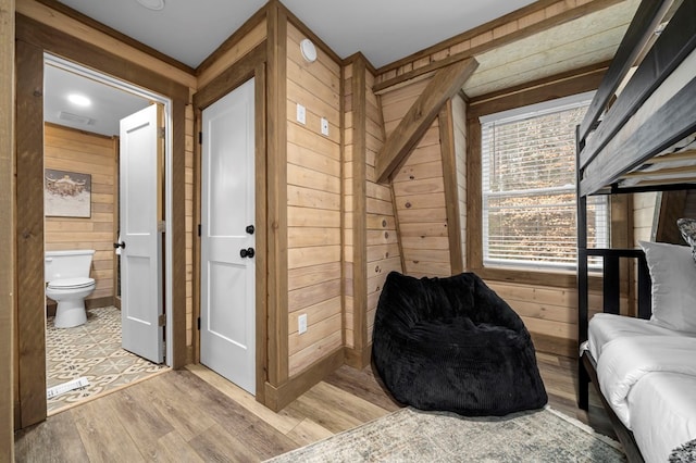 living area with wooden walls and light wood-type flooring