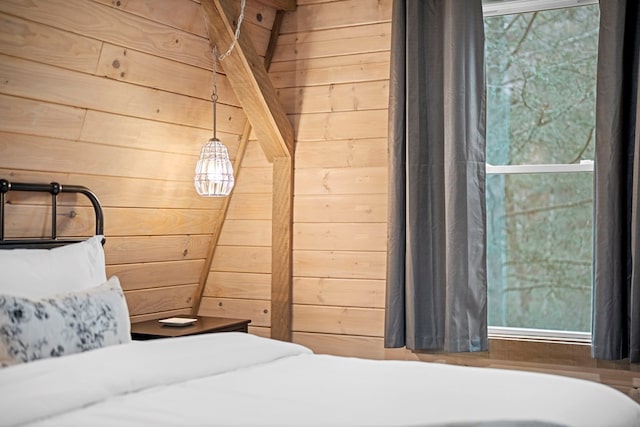 bedroom featuring wood walls