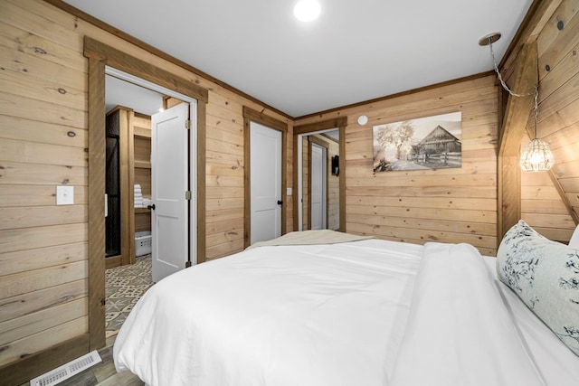 bedroom featuring wood walls