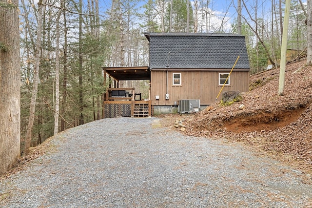 view of home's exterior with central AC unit and a wooden deck