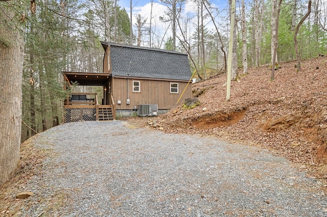 view of home's exterior with a wooden deck and central air condition unit