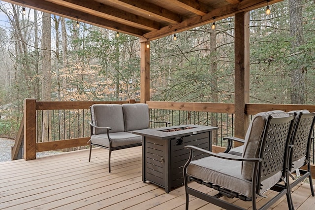 deck with an outdoor living space with a fire pit