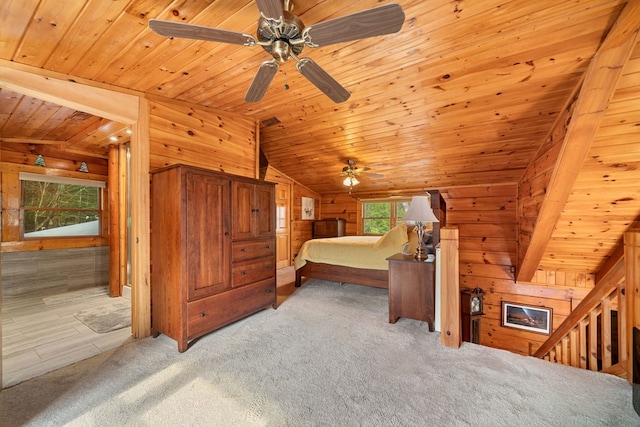 carpeted bedroom with wood ceiling, vaulted ceiling, and wood walls