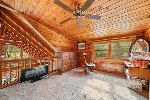 unfurnished room with lofted ceiling, wooden walls, carpet, and wooden ceiling